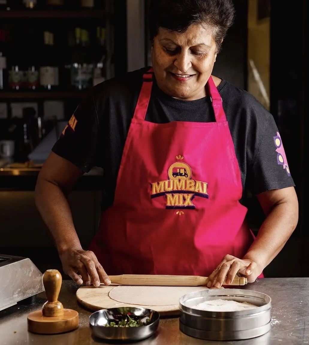 Mum rolling out dough by hand at a Mumbai Mix stall