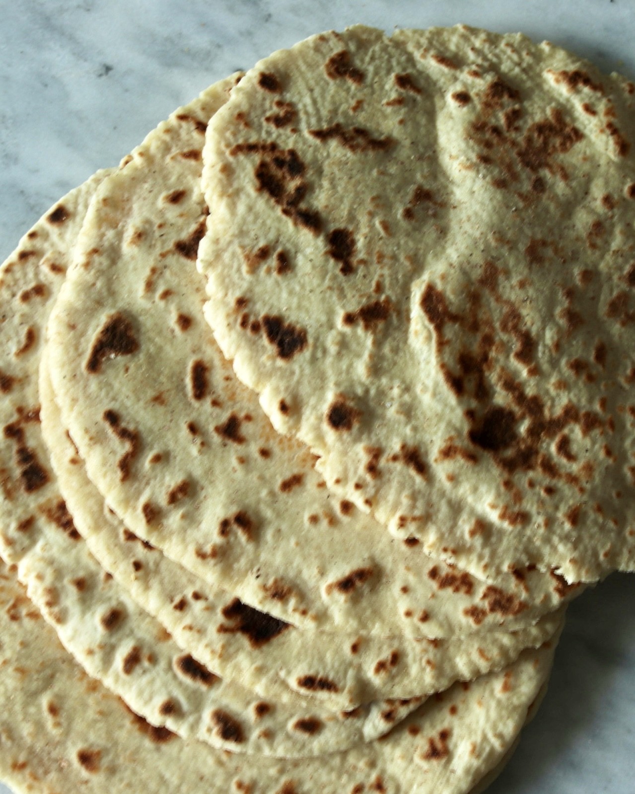 Soft homemade naan showing the fluffy interior