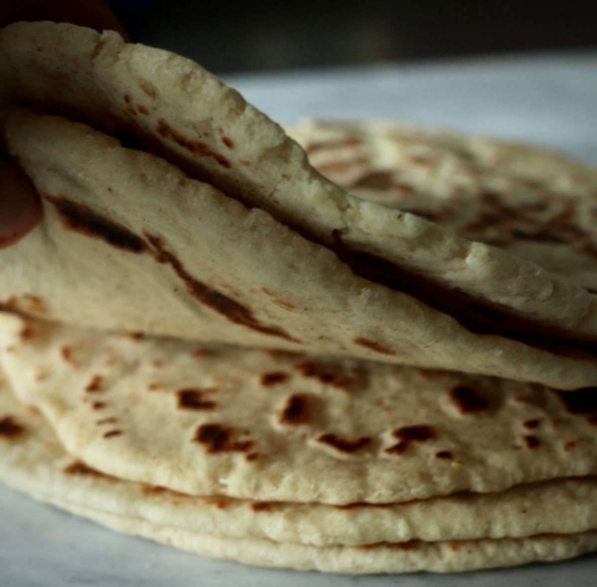 Freshly cooked homemade naan stacked and ready to serve