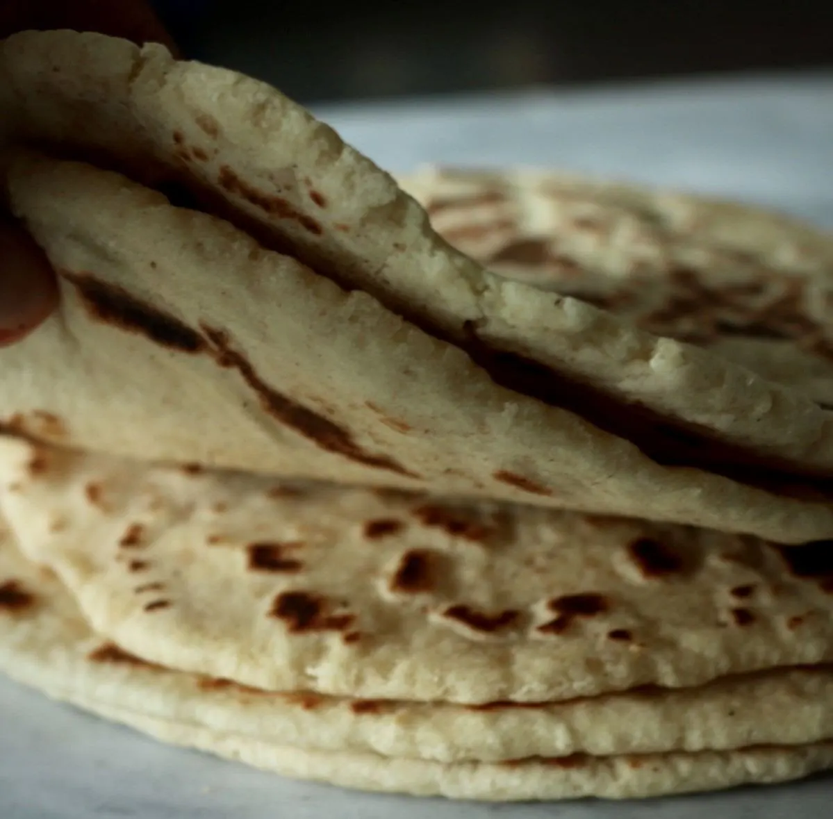 Freshly cooked homemade naan stacked and ready to serve